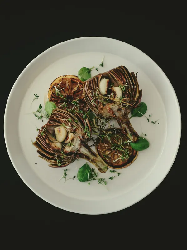 Roasted artichokes on a white plate